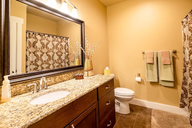 bathroom featuring baseboards, toilet, a shower with curtain, tile patterned floors, and vanity