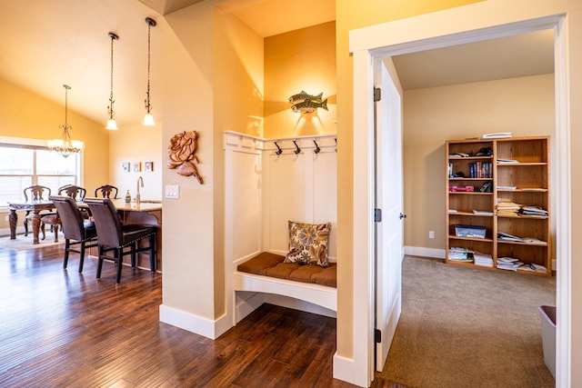 mudroom with dark wood finished floors, a notable chandelier, and baseboards