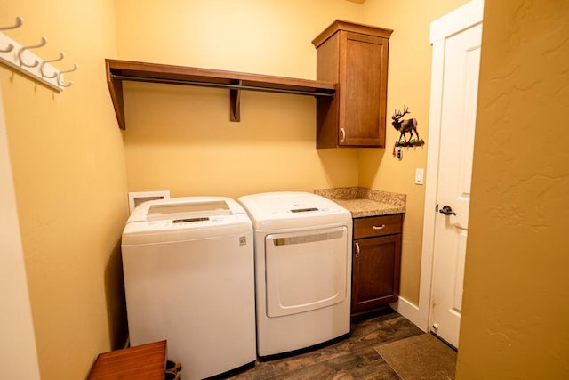 laundry area featuring cabinet space, dark wood finished floors, and independent washer and dryer