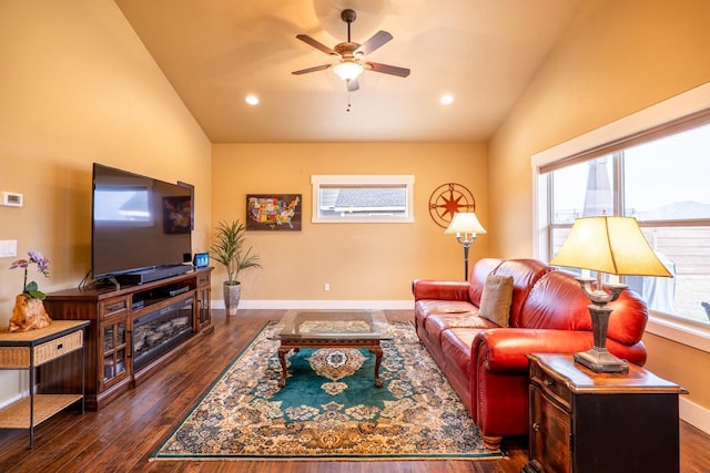 living area with dark wood-type flooring, lofted ceiling, and baseboards