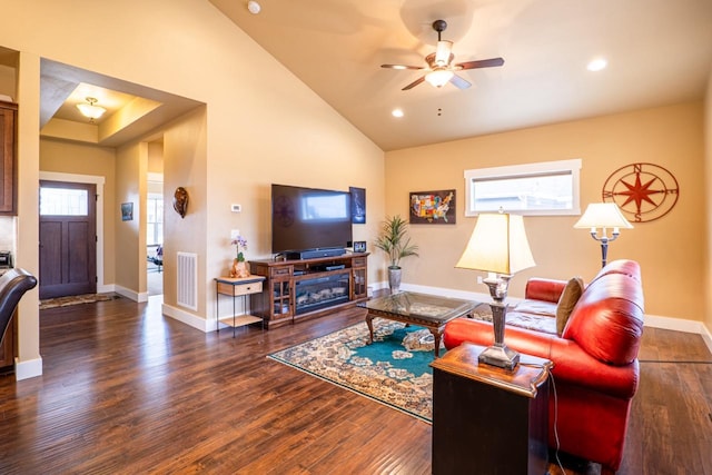 living room with lofted ceiling, baseboards, visible vents, and wood finished floors