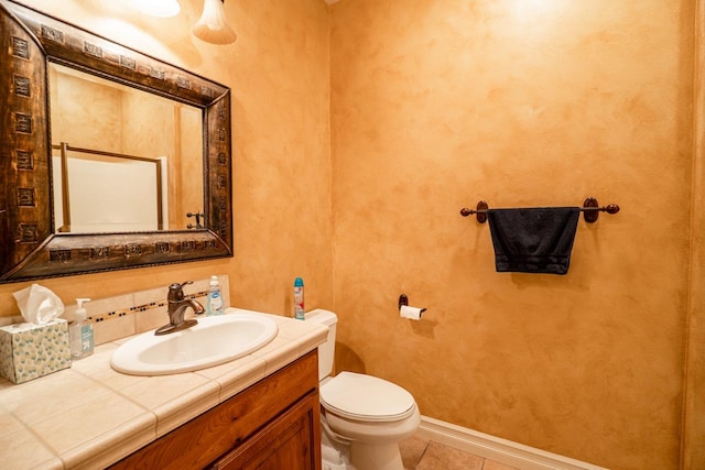 bathroom featuring toilet, tile patterned flooring, and vanity