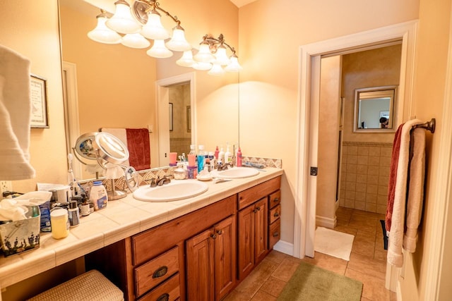 full bathroom featuring double vanity, a sink, and tile patterned floors