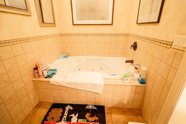 bathroom with tile walls, tile patterned flooring, and a jetted tub