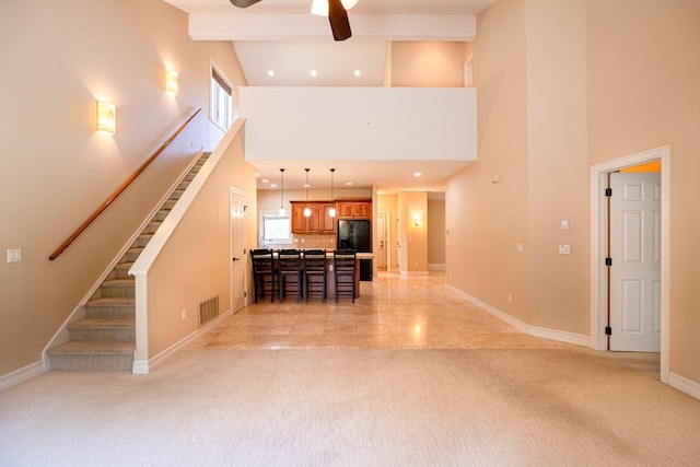 159 Fairway Blvd, Kalispell, MT 59901 - unfurnished living room with high vaulted ceiling, light colored carpet, a ceiling fan, recessed lighting, and stairs