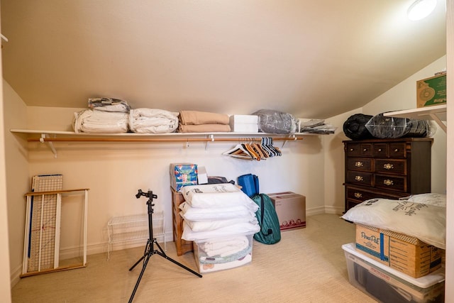 spacious closet featuring lofted ceiling and carpet flooring