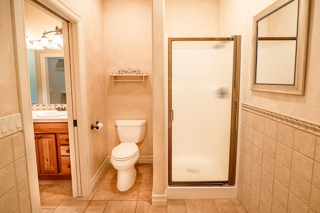 159 Fairway Blvd, Kalispell, MT 59901 - bathroom featuring a stall shower, vanity, tile patterned flooring, and tile walls