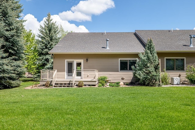 159 Fairway Blvd, Kalispell, MT 59901 - back of property featuring a deck, a lawn, and roof with shingles