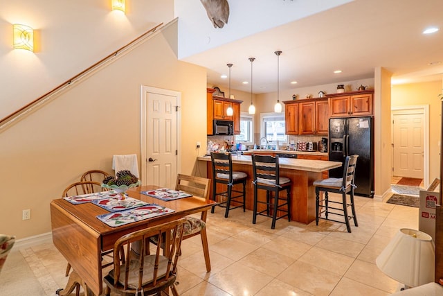 dining space with recessed lighting, baseboards, and light tile patterned floors