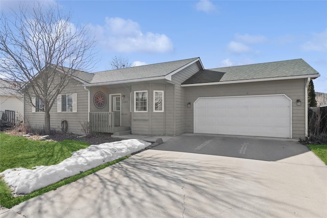 single story home featuring driveway, roof with shingles, and an attached garage