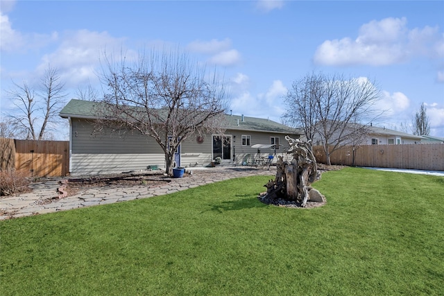 back of house featuring a patio area, a fenced backyard, and a lawn