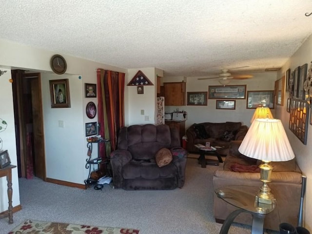 carpeted living area with a textured ceiling, ceiling fan, and baseboards