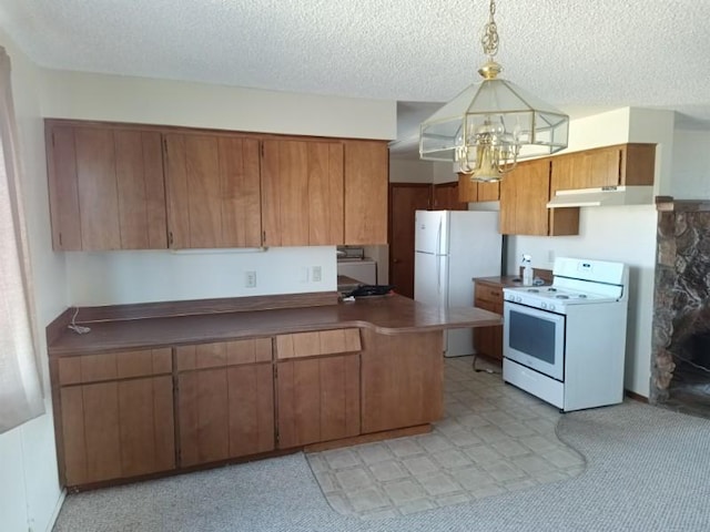 kitchen with a chandelier, a textured ceiling, under cabinet range hood, white appliances, and brown cabinets