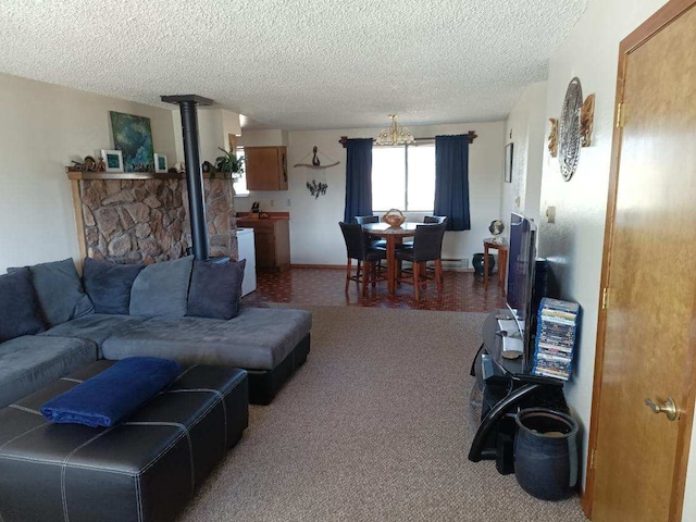 living room with a wood stove, carpet flooring, and a textured ceiling