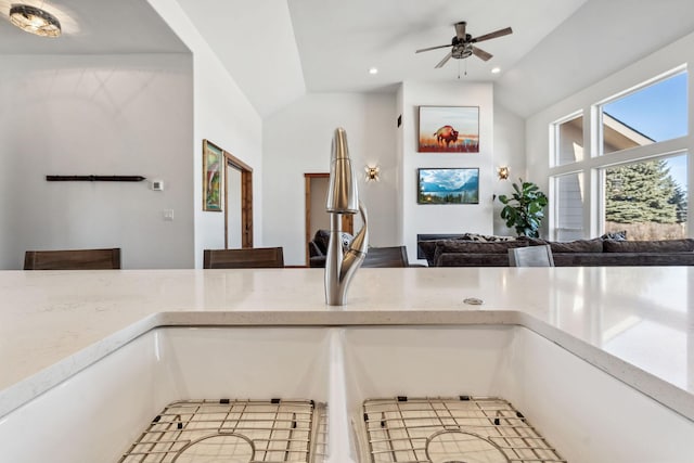 interior details featuring a ceiling fan, recessed lighting, a sink, and light stone countertops