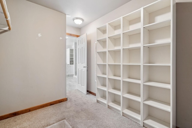 hall with carpet flooring and baseboards