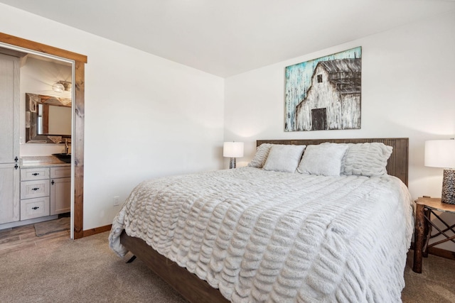 bedroom with light colored carpet and baseboards