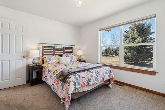 carpeted bedroom with visible vents and baseboards