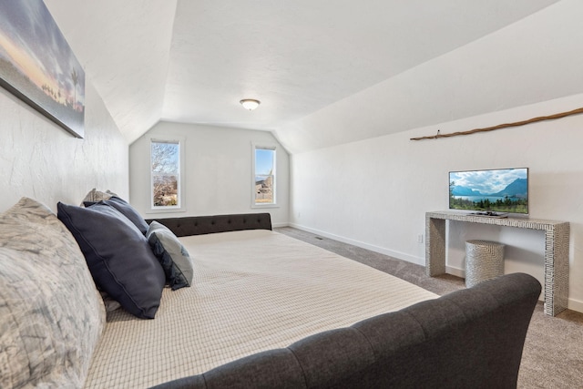 carpeted bedroom featuring vaulted ceiling and baseboards