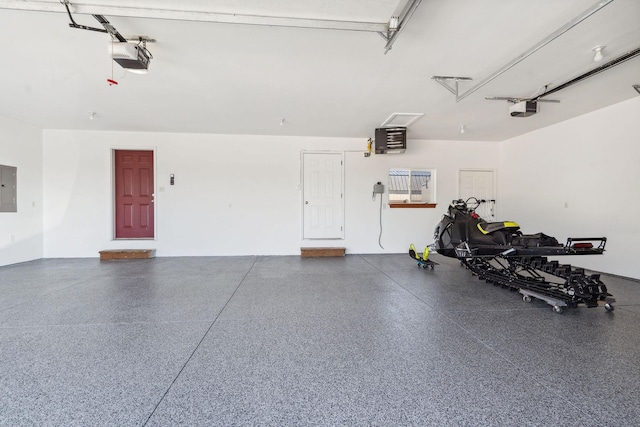 garage featuring electric panel and a garage door opener