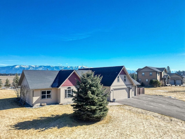 single story home featuring a garage and a mountain view