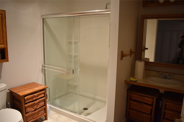full bath with vanity, toilet, and a shower stall