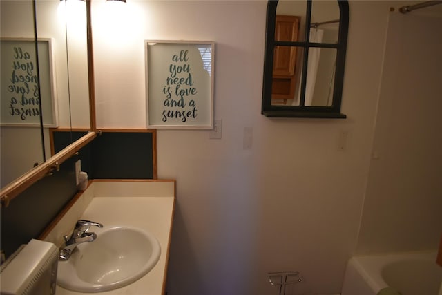 full bathroom with a sink, a tub, and a shower