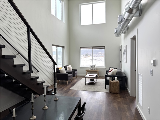 264A Blackberry Loop Unit A, Whitefish, MT 59937 - living room featuring dark wood finished floors, plenty of natural light, a towering ceiling, and stairway