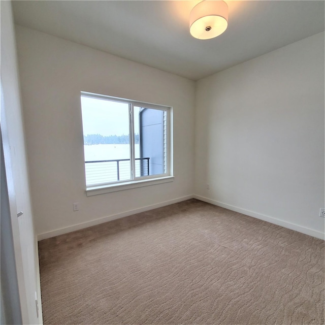 empty room with carpet floors and baseboards