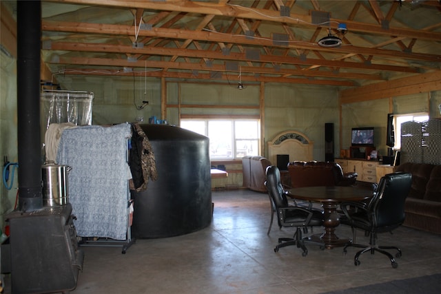 dining area with concrete floors and vaulted ceiling