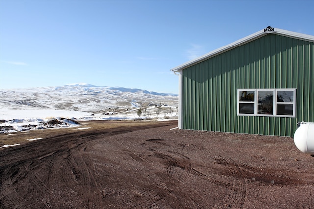 exterior space featuring board and batten siding and a mountain view