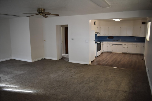 kitchen featuring electric range, dark carpet, white cabinetry, and under cabinet range hood