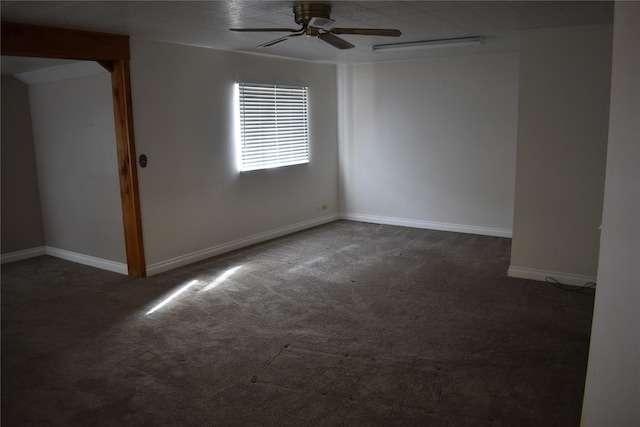 unfurnished room with carpet flooring, ceiling fan, and baseboards