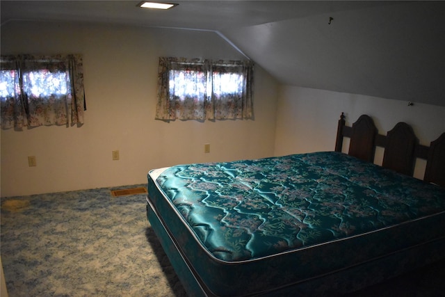 bedroom with lofted ceiling and carpet flooring