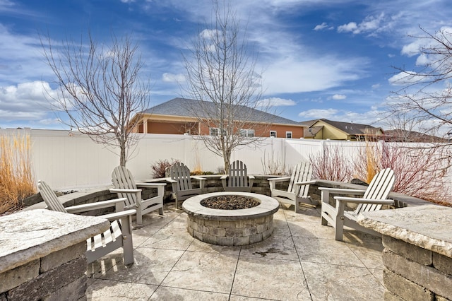 view of patio / terrace featuring an outdoor fire pit and a fenced backyard