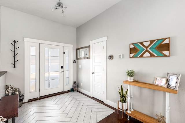 foyer featuring baseboards