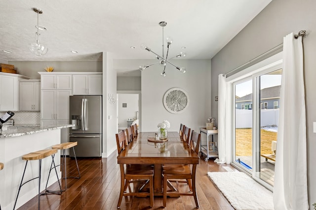 dining room with a chandelier and dark wood-type flooring