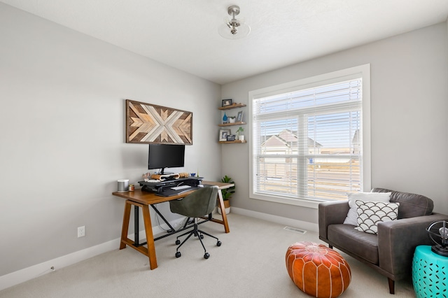 carpeted office space featuring visible vents and baseboards