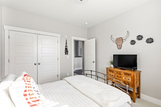 bedroom featuring baseboards, a closet, and carpet floors