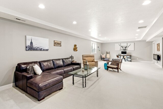 living area featuring recessed lighting, visible vents, baseboards, and light colored carpet