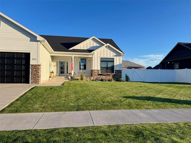 modern inspired farmhouse with stone siding, board and batten siding, and fence