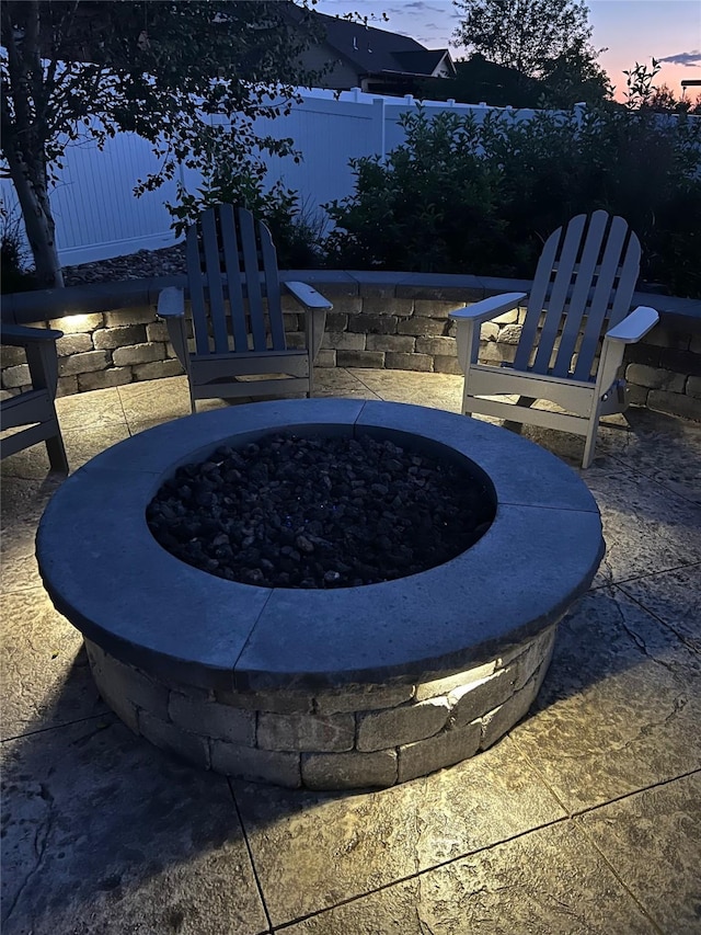 view of patio / terrace featuring an outdoor fire pit and fence