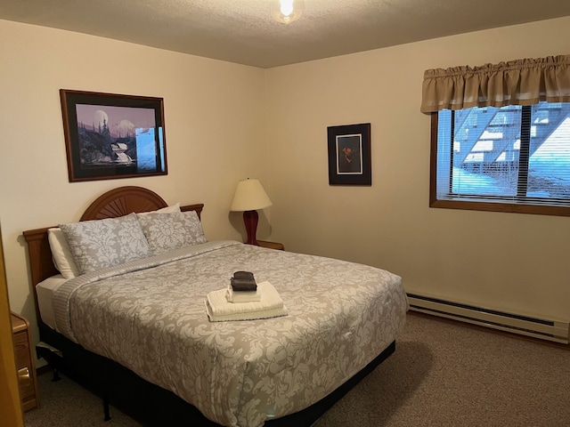 bedroom with carpet floors, a textured ceiling, and a baseboard radiator