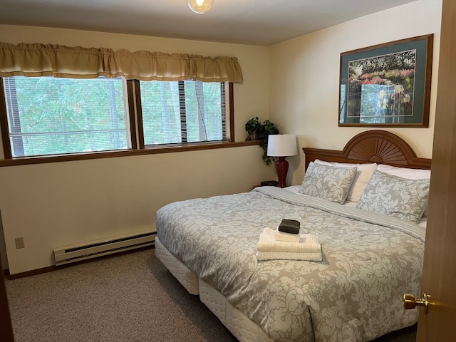 bedroom featuring a baseboard heating unit and carpet