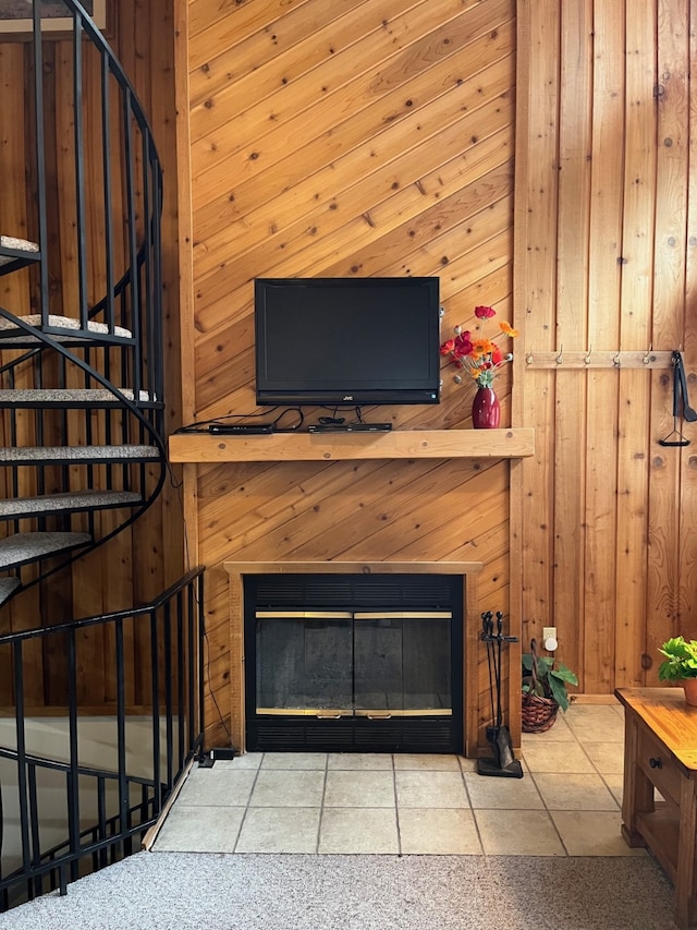 details featuring a glass covered fireplace and wooden walls