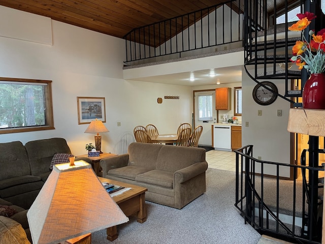 living area with wooden ceiling, baseboards, and a towering ceiling