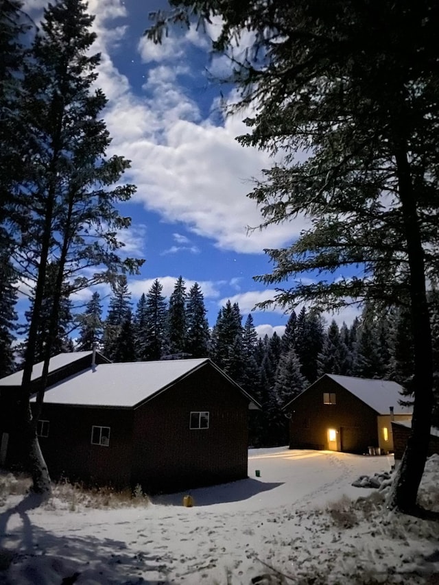 view of snow covered exterior with a garage