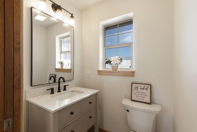 bathroom featuring toilet and vanity