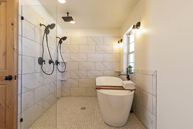 bathroom with a soaking tub, tile walls, and a tile shower