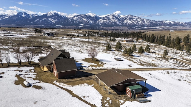 snowy aerial view with a mountain view